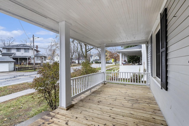 wooden terrace featuring covered porch