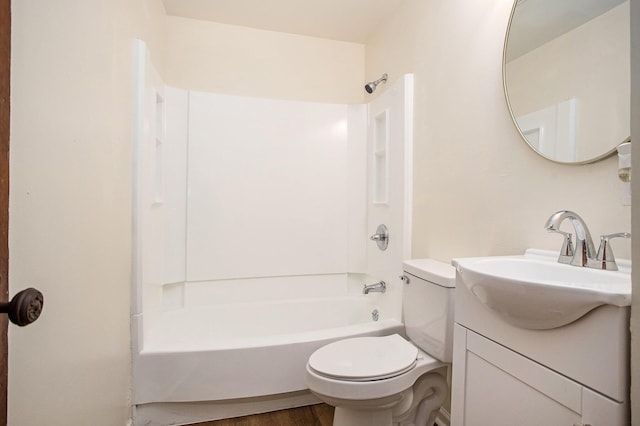 full bathroom featuring hardwood / wood-style flooring, vanity, toilet, and shower / washtub combination