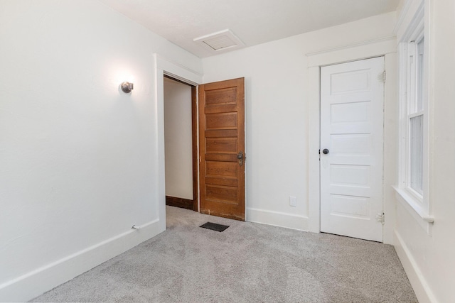 unfurnished room featuring light colored carpet