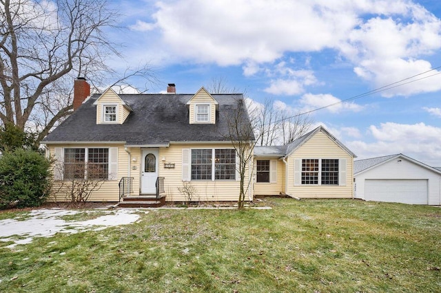 cape cod-style house featuring an outbuilding, a garage, and a front yard