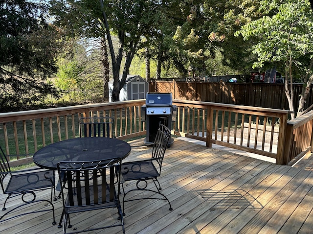 deck featuring area for grilling and a storage shed