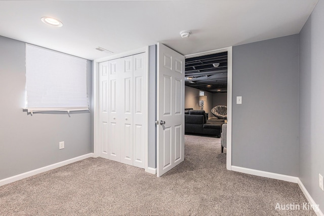 unfurnished bedroom with a closet and carpet floors