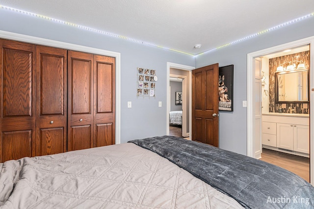 bedroom featuring a closet and ensuite bath