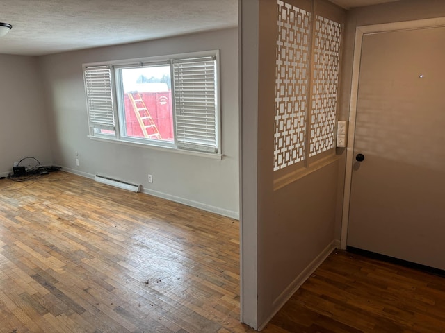 entryway featuring hardwood / wood-style floors and baseboard heating