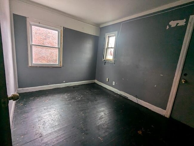 empty room with dark wood-type flooring