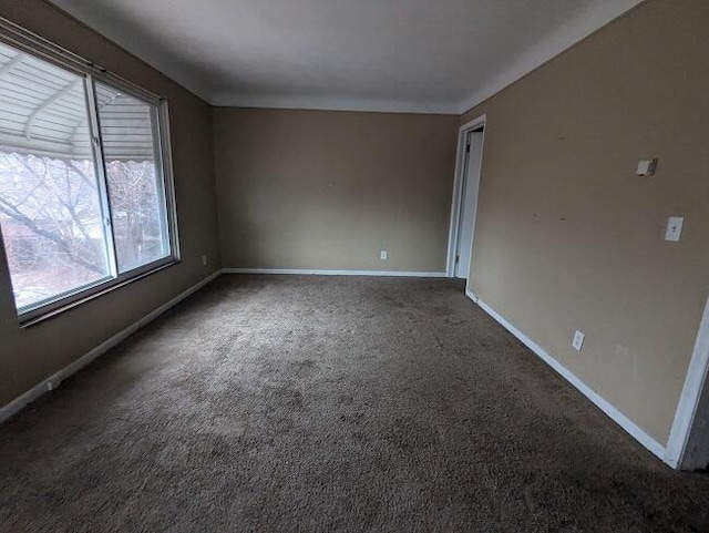 empty room featuring dark carpet