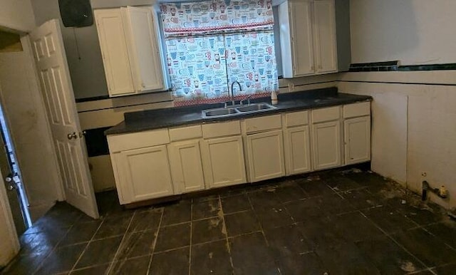 kitchen featuring white cabinetry and sink