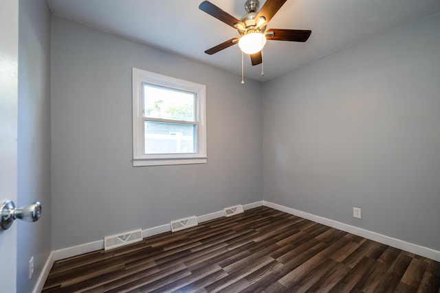 empty room with dark wood-type flooring and ceiling fan