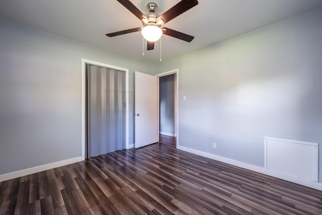 unfurnished bedroom featuring ceiling fan, dark hardwood / wood-style flooring, and a closet