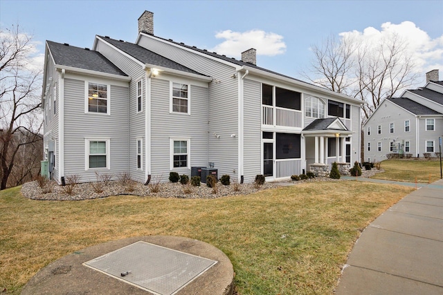 view of front of home featuring a front lawn and cooling unit