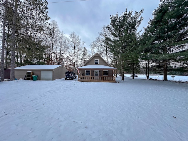 view of front of house with a garage, an outbuilding, and covered porch