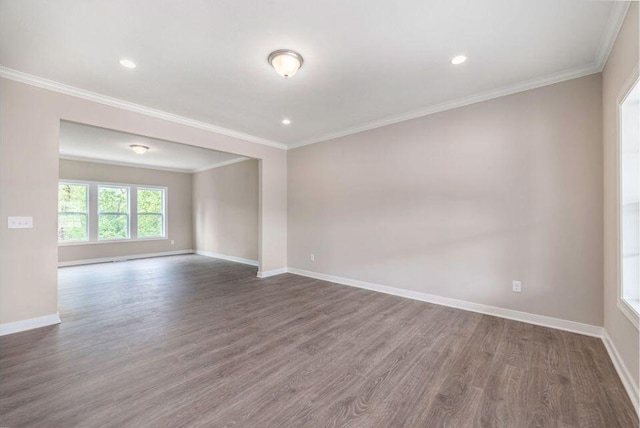 empty room featuring ornamental molding and dark hardwood / wood-style floors