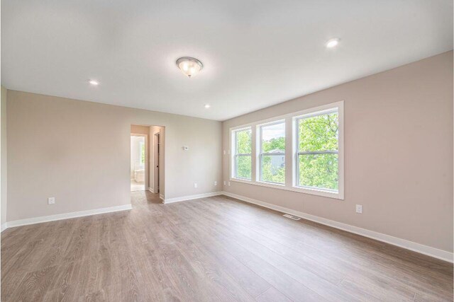 unfurnished room with light hardwood / wood-style flooring