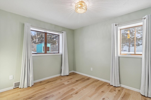 spare room with light wood-type flooring