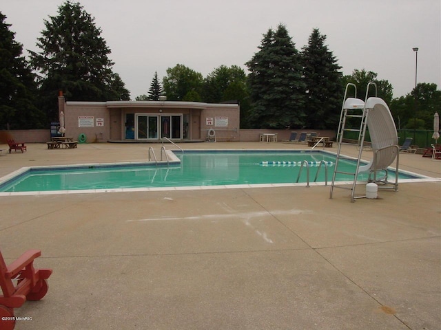 view of pool with a patio and a water slide