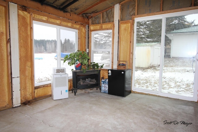 sunroom featuring a wood stove