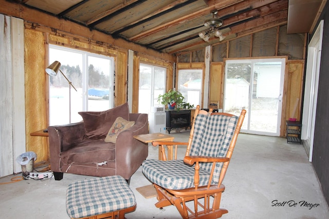 sunroom featuring ceiling fan, a healthy amount of sunlight, and vaulted ceiling