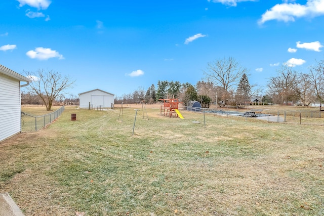 view of yard featuring a playground and a shed