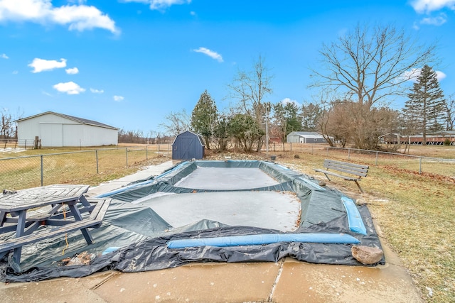 view of swimming pool featuring a shed