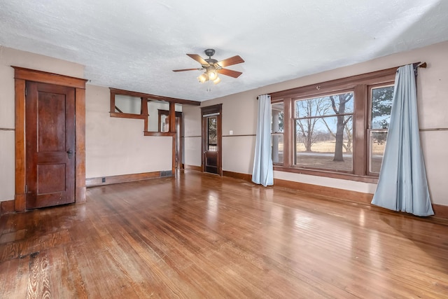 interior space with ceiling fan, hardwood / wood-style floors, and a textured ceiling