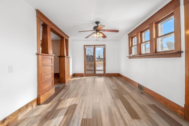 empty room featuring ceiling fan and light hardwood / wood-style floors