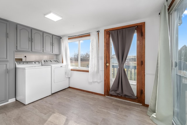 washroom featuring separate washer and dryer and cabinets