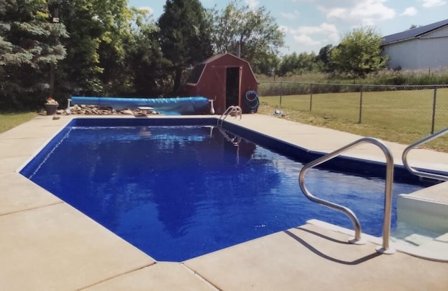 view of pool featuring a shed