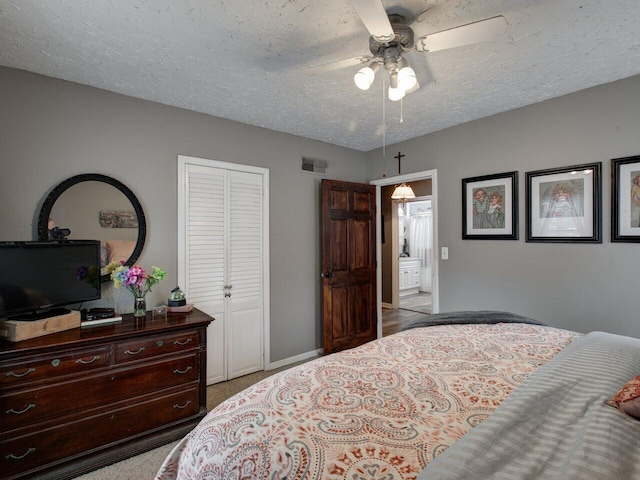 bedroom featuring ceiling fan, light colored carpet, a closet, and a textured ceiling