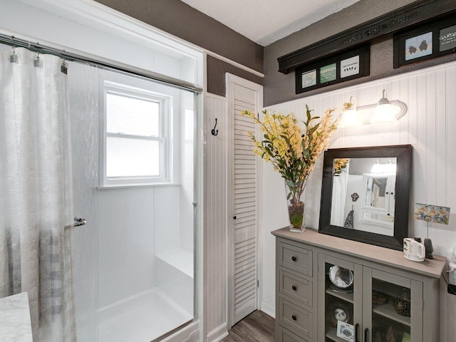 bathroom featuring hardwood / wood-style floors and walk in shower