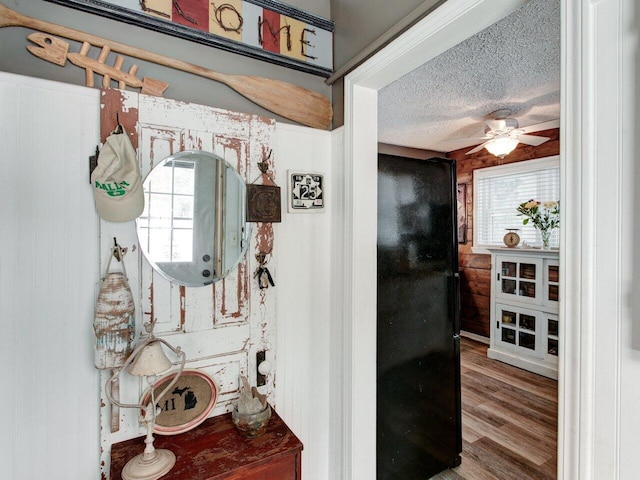 interior space with ceiling fan, hardwood / wood-style floors, and a textured ceiling