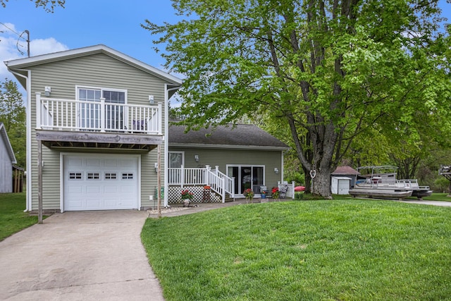 view of front facade with a garage, a front lawn, and a balcony