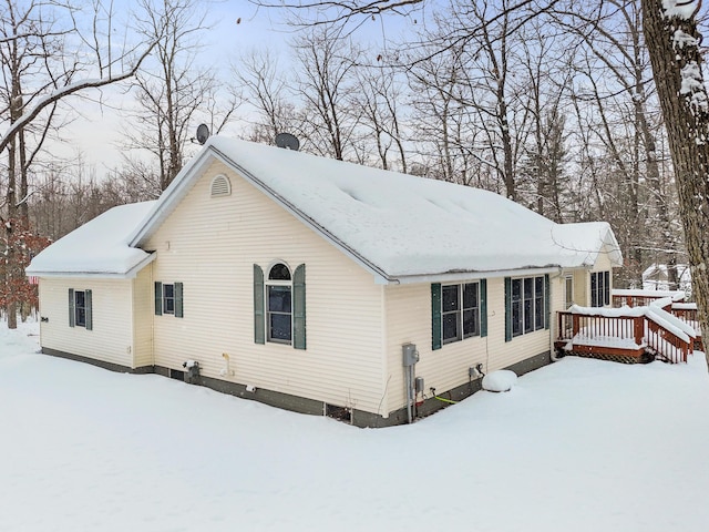 view of snowy exterior with a deck