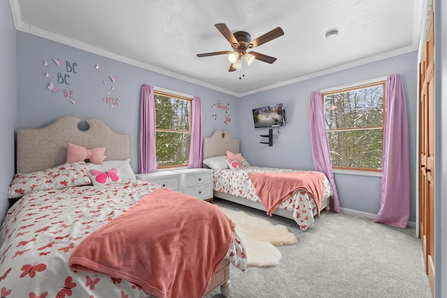 carpeted bedroom featuring ornamental molding and ceiling fan