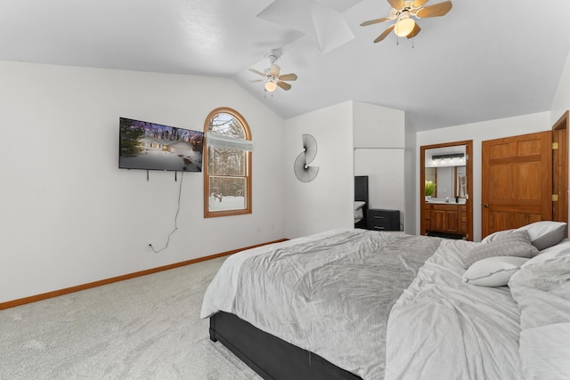 bedroom with vaulted ceiling, carpet flooring, ceiling fan, and ensuite bath