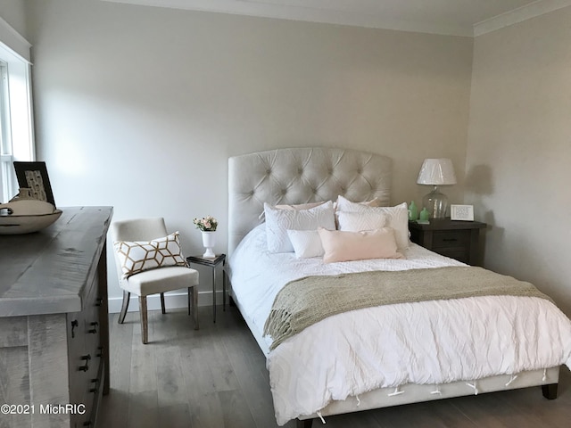 bedroom featuring hardwood / wood-style flooring and crown molding