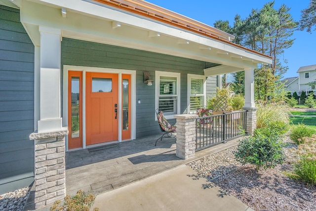 view of exterior entry featuring a porch