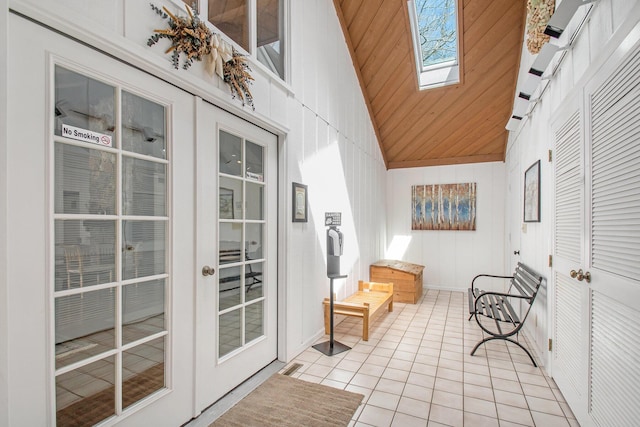 sunroom featuring lofted ceiling with skylight, wood ceiling, and visible vents