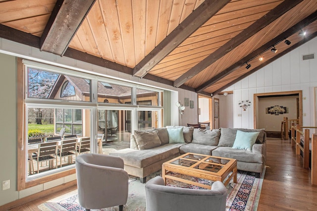sunroom / solarium with lofted ceiling with beams, wood ceiling, visible vents, and track lighting