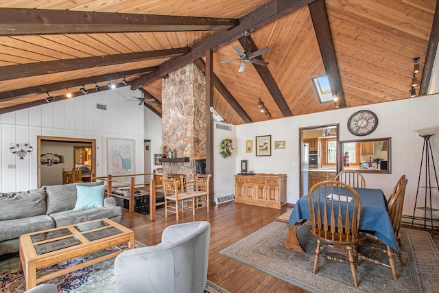 living area featuring wooden ceiling, hardwood / wood-style flooring, ceiling fan, and beam ceiling