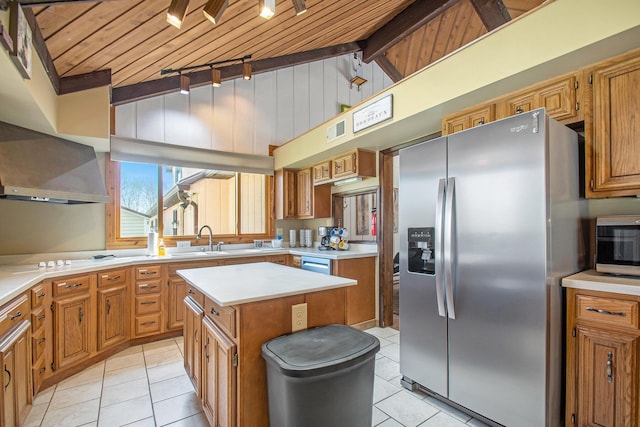 kitchen with a center island, light tile patterned floors, light countertops, lofted ceiling with beams, and appliances with stainless steel finishes