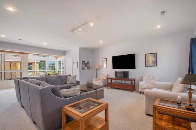 living area featuring recessed lighting, visible vents, and light colored carpet