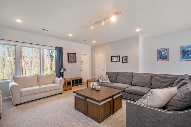living room featuring light carpet, visible vents, and recessed lighting