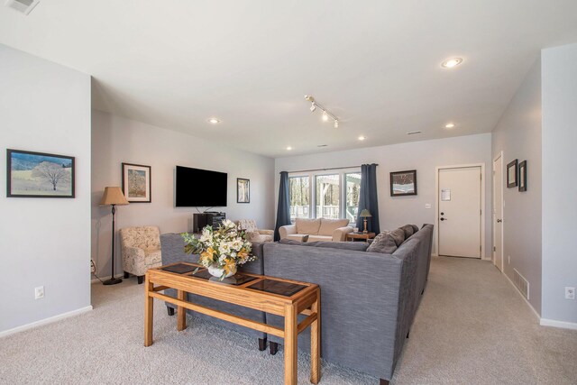 living room featuring baseboards, recessed lighting, visible vents, and light colored carpet