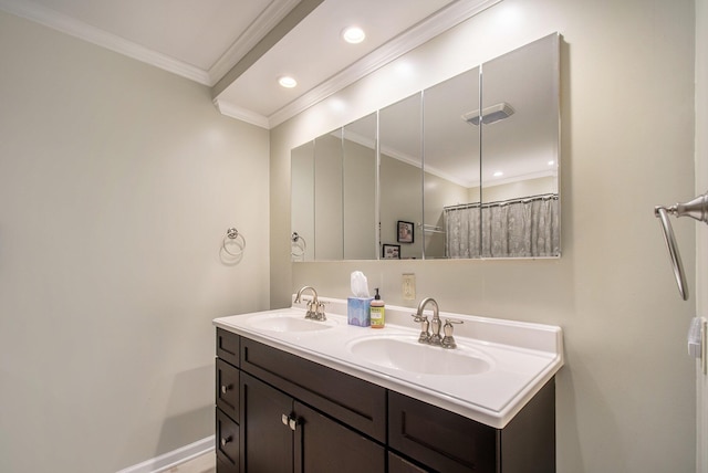 bathroom with ornamental molding, recessed lighting, a sink, and double vanity