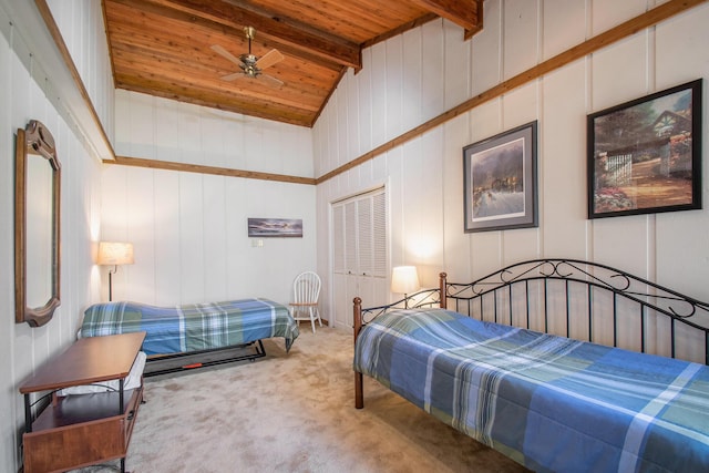 carpeted bedroom featuring lofted ceiling with beams, wood ceiling, and a closet
