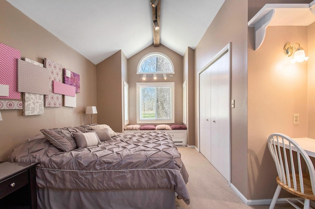 bedroom with light carpet, vaulted ceiling with beams, baseboards, and a closet