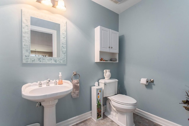 bathroom featuring visible vents, toilet, and baseboards