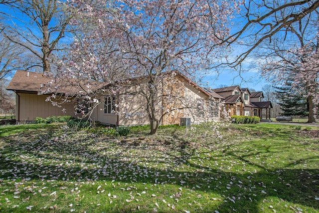 view of property exterior with a lawn