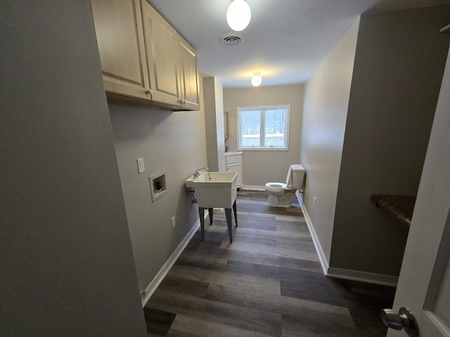 laundry area with cabinets, hookup for a washing machine, and dark hardwood / wood-style floors