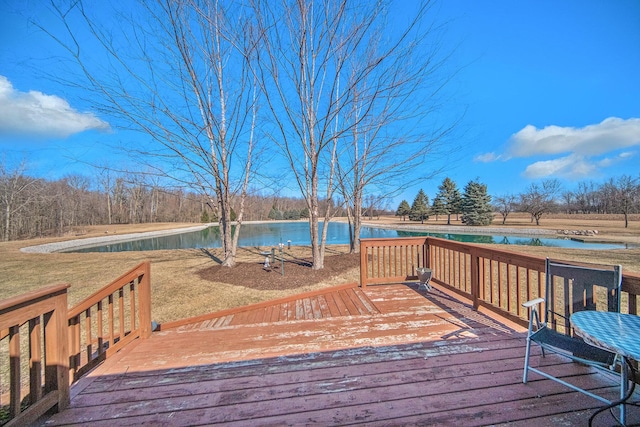 wooden deck with a yard and a water view